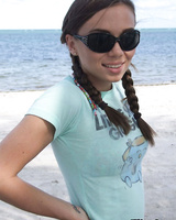 Sweet teen girl Alexiss Capri showing off nice ass in thong underwear on beach