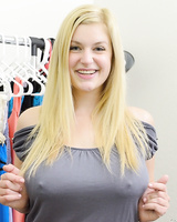 Busty blonde Danielle flashes her big tits and bald pussy in the uniform shop