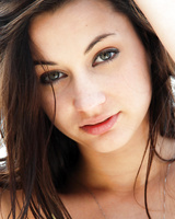 Brunette solo girl Georgia Jones struts her naked body on a deserted beach