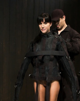 Dark haired female Gia DiMarco is ensconced in a straitjacket and tortured