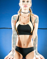 Tattooed female wrestler Sarah Jessie exposes her big tits and sexy tight body