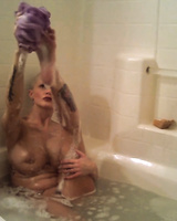 Nude female Joslyn James masturbates in the bathtub while taking a bath