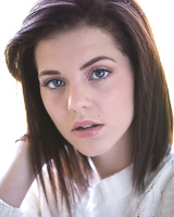 Fresh faced teen Kiera Winters removes her clothes for nude poses on balcony