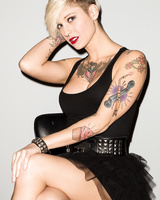 Tattooed female Kleio Valentien slips out of her black dress for nude poses
