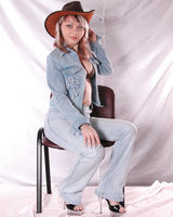 Girl in hat poses on the chair