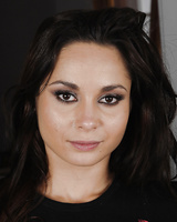 Euro model Aurelly Rebel strips off blue jeans to pose nude on leather chair