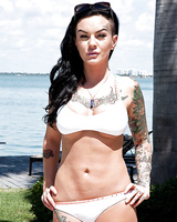 Tattooed whore Lolo Luscious exposing big hooters in swimming pool