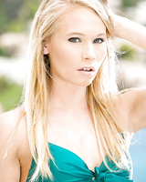 Beautiful blonde teenager Dakota James peels off her bikini outdoors