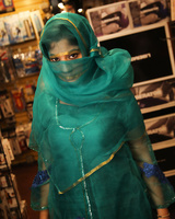 Indian female Nadia Ali sucks off a big black cock thru a glory hole