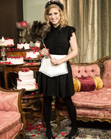 Smiling blonde maid flashes her ass and underwear for her boss lady