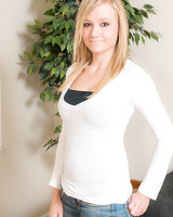 Attractive blonde Samantha Sith undressing to pose naked wearing only socks