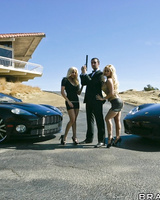 Blondes Gina Lynn & Shyla Stylez expose their big boobs beside man with a gun