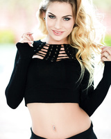 Pornstar Sydney Cole does a striptease prior to stroking a BBC