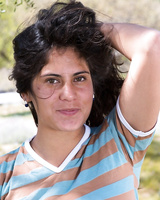 Busty newbie Sally spreading naked under a tree showing hairy muff close up