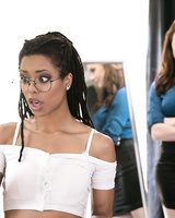 Interracial lesbians stick a butt plug in each others asshole on bed