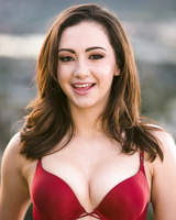 Babe Lily Jordan strips down near bench in the background of small quiet city