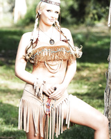 Blonde female Phoenix Marie works clear of her Indian attire in the woods