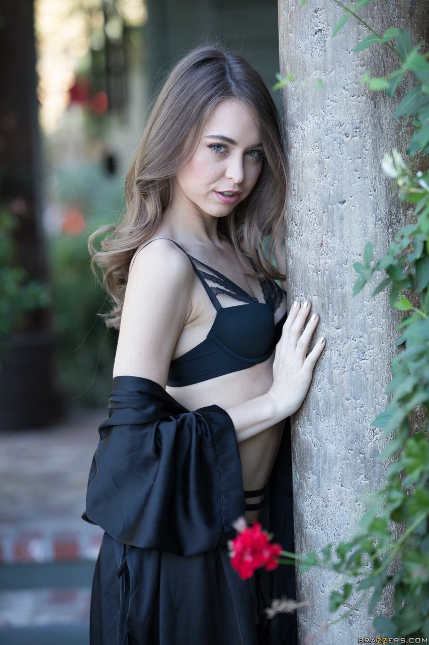 White girl Riley Reid models outdoors in black lingerie with matching hosiery