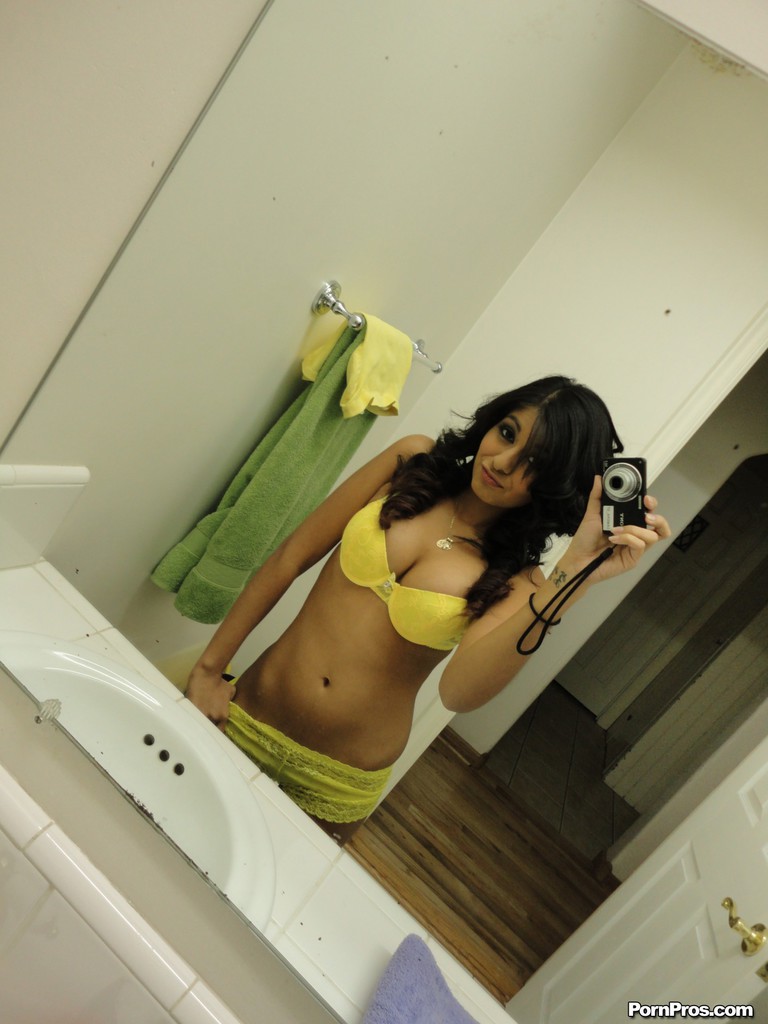 Brunette girlfriend type Ruby Reyes takes self shots on exposed boob in mirror