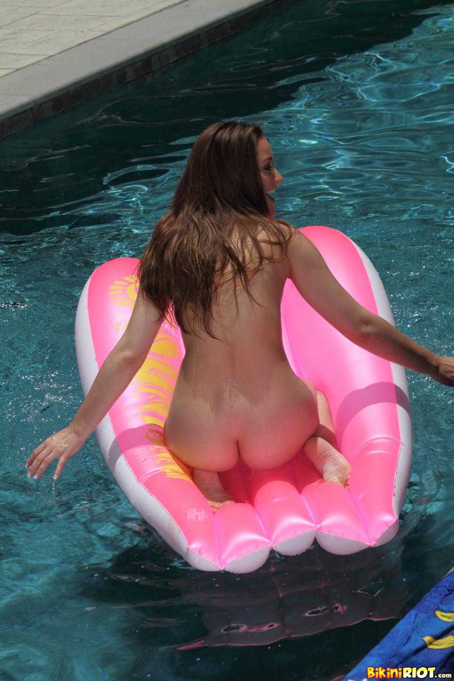Sweet teen brunette Dani Daniels takes off her green mini bikini in the pool