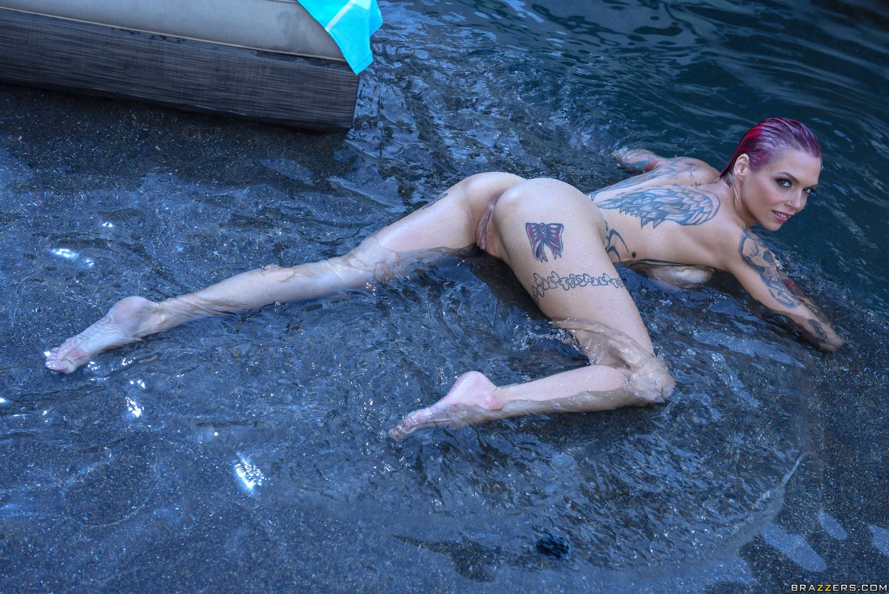 Tattooed solo female Anna Bell Peaks models soaking wet in a bikini