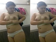 Sweet and young Indian girl strips her clothes in the bathroom and touches big nipples