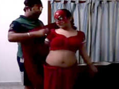 Masked Desi woman is wearing a red saree while dancing and fooling with XXX