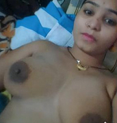 Desi chick is laying naked in the bedroom and she grabs a camera for XXX